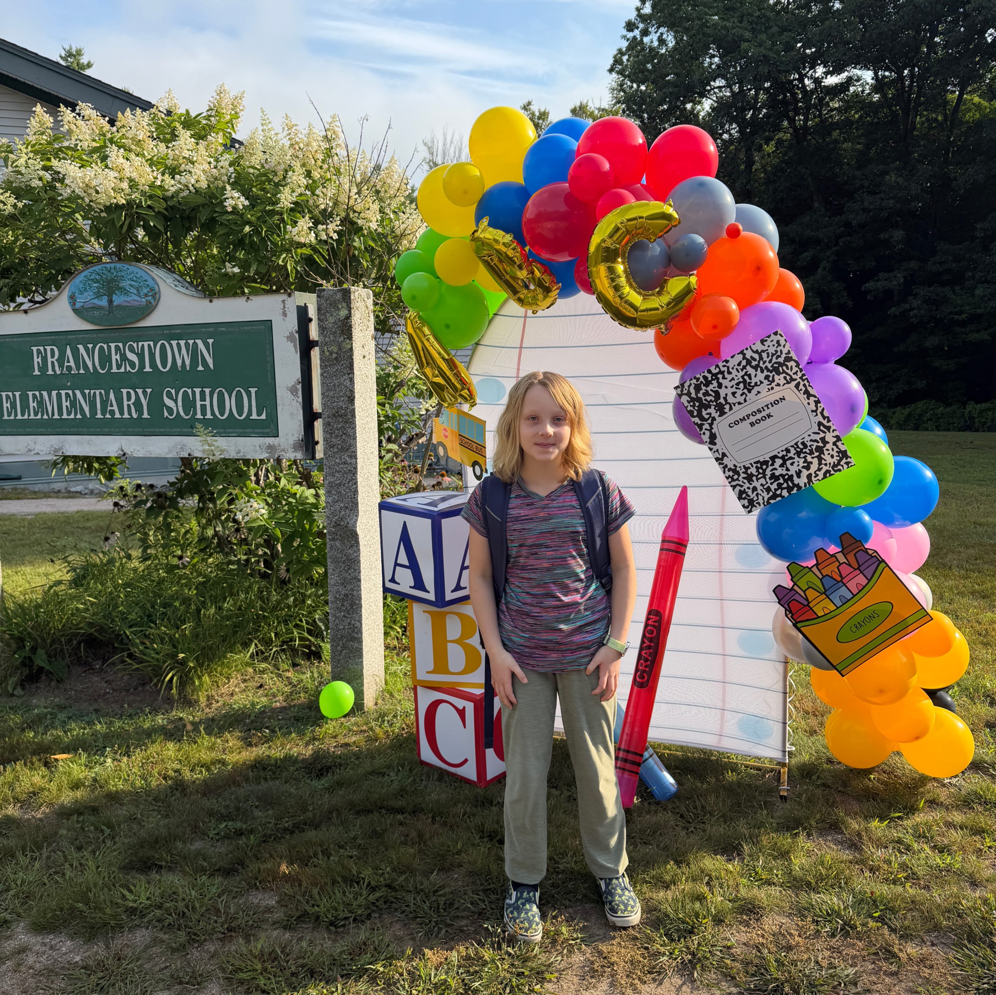 student with sign and balloons